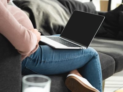 cropped view of pregnant woman having online consultation with doctor on laptop with blank screen